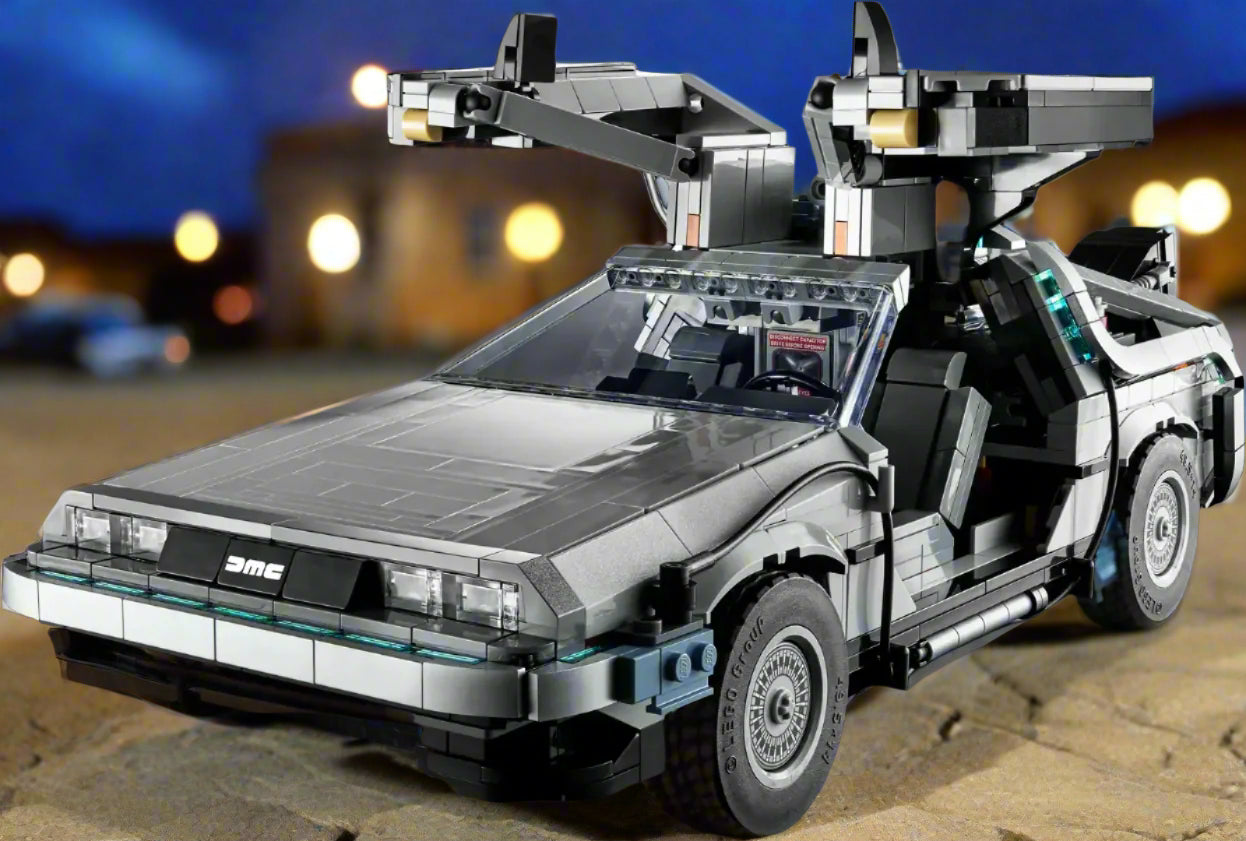 Toy model of a futuristic car resembling the DeLorean from Back to the Future on a wooden surface.